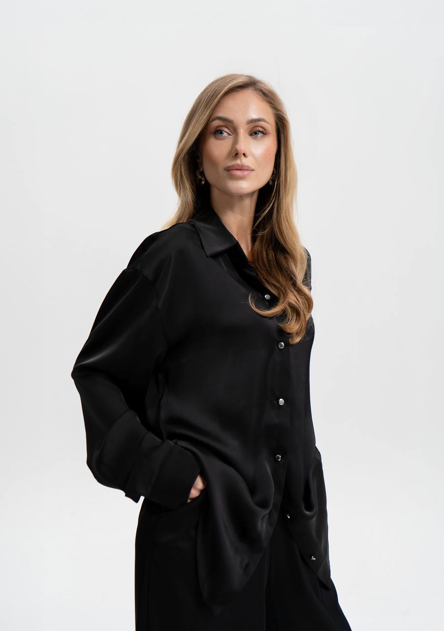 Woman wearing a black outfit against a white background