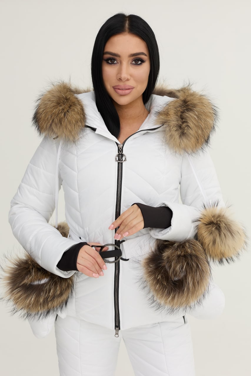 Woman wearing a white puffer jacket with fur trim on a plain background