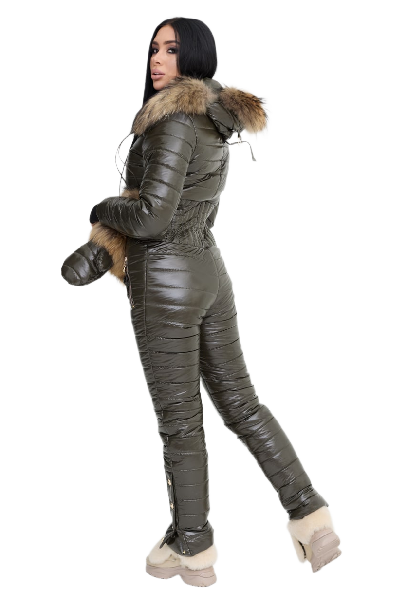 Person wearing a green puffer jumpsuit with fur trim on a white background