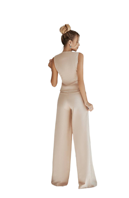 Woman wearing a beige jumpsuit on a white background