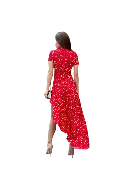 Woman wearing a red polka dot dress on a white background