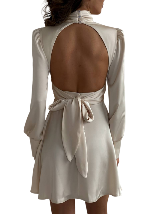 Beige dress with open back and long sleeves on a white background