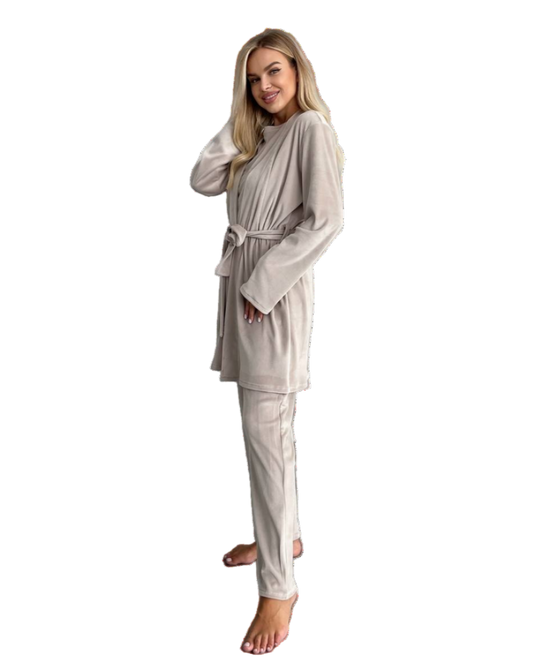 Woman wearing a beige robe and pajama set on a white background