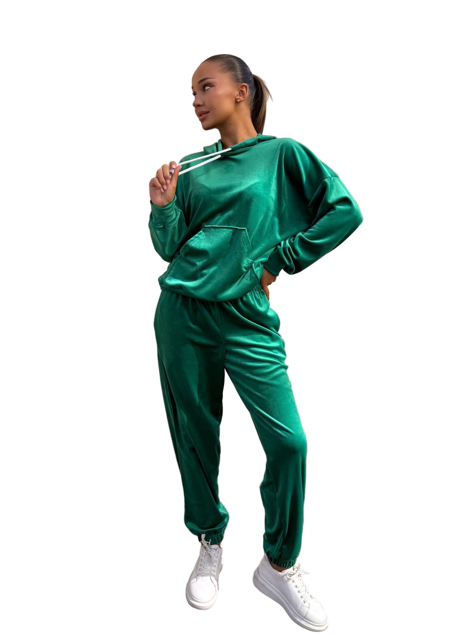 Woman wearing a green tracksuit on a white background
