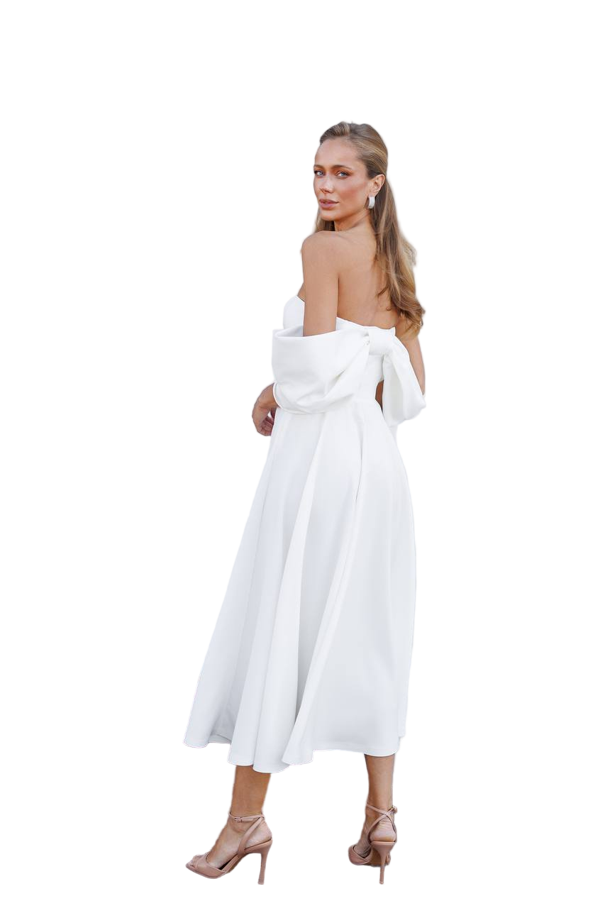 Woman wearing a white dress with a plain background