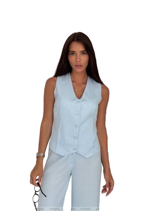 Woman wearing a light blue sleeveless top and pants on a white background