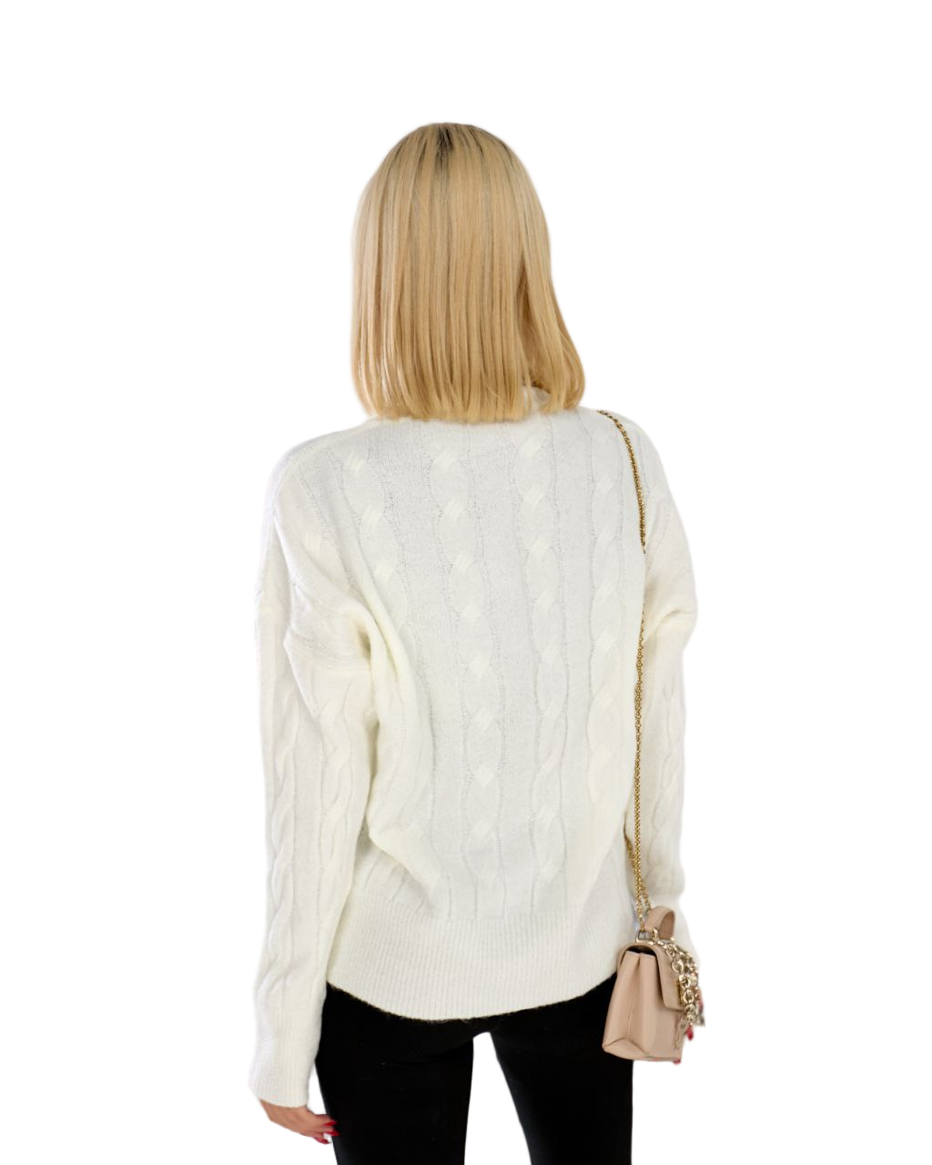 Woman wearing a white cable knit sweater with a beige handbag on a white background