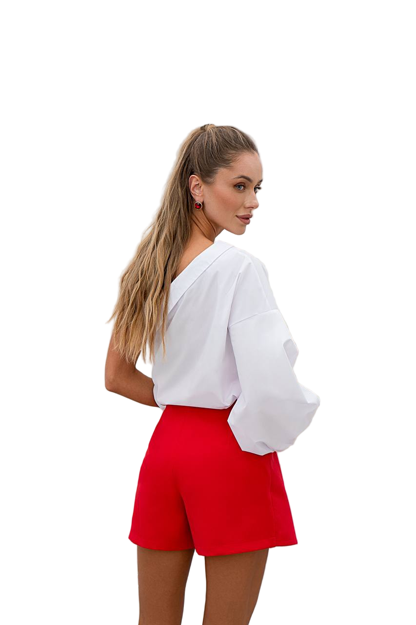 Woman wearing a white blouse and red shorts on a white background