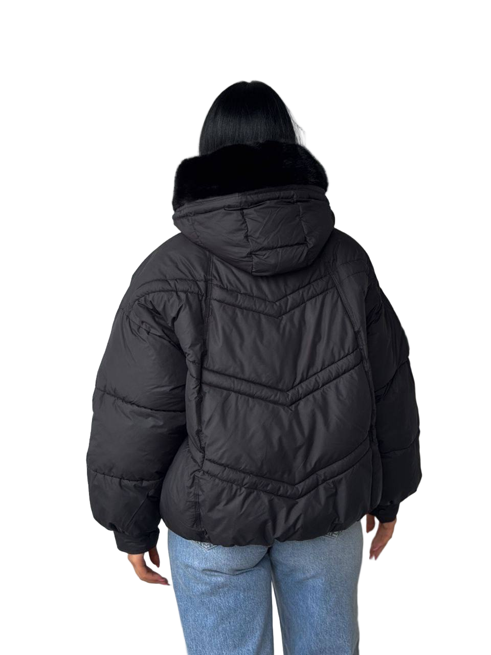 Person wearing a black puffer jacket with a hood on a white background