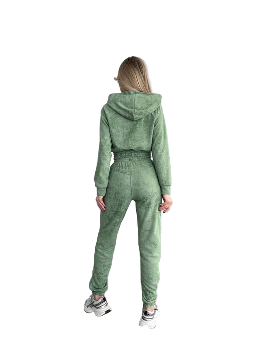 Person wearing a green tracksuit on a white background