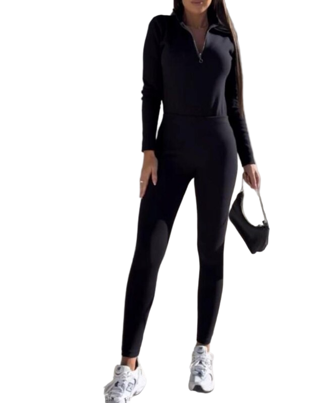 Woman wearing a black jumpsuit on a white background