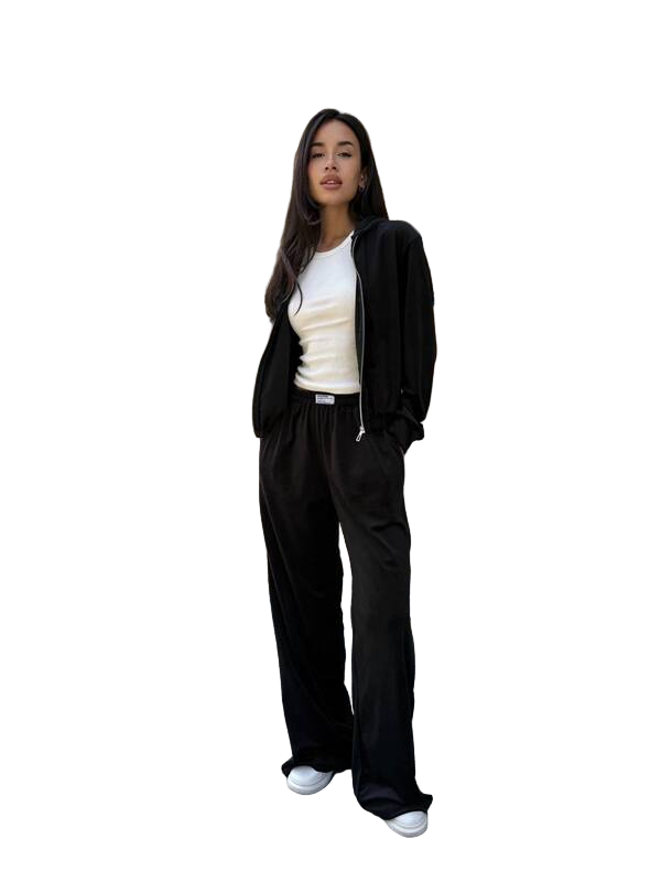 Person wearing a black tracksuit with a white shirt on a white background
