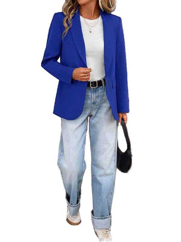 Person wearing a blue blazer, white shirt, and jeans with a black handbag on a white background.