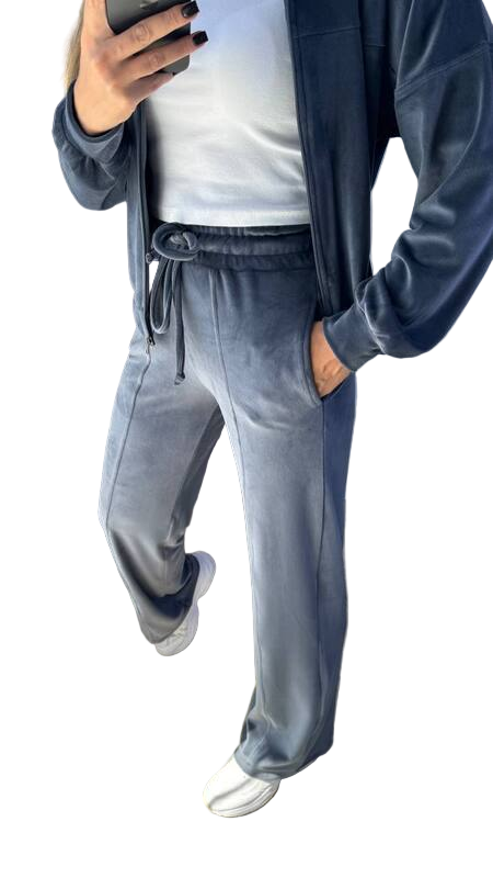 Person wearing a blue tracksuit with a white background