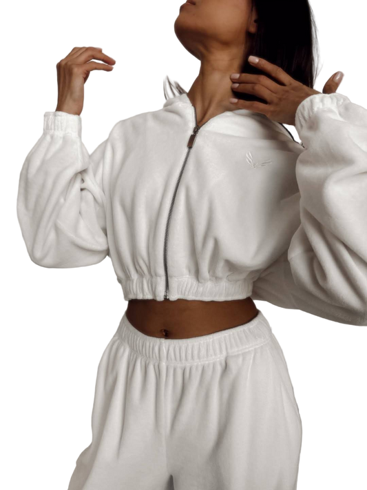 Person wearing a white tracksuit on a white background