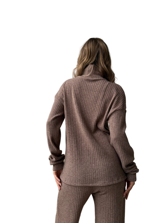 Woman wearing a brown ribbed knit outfit on a white background