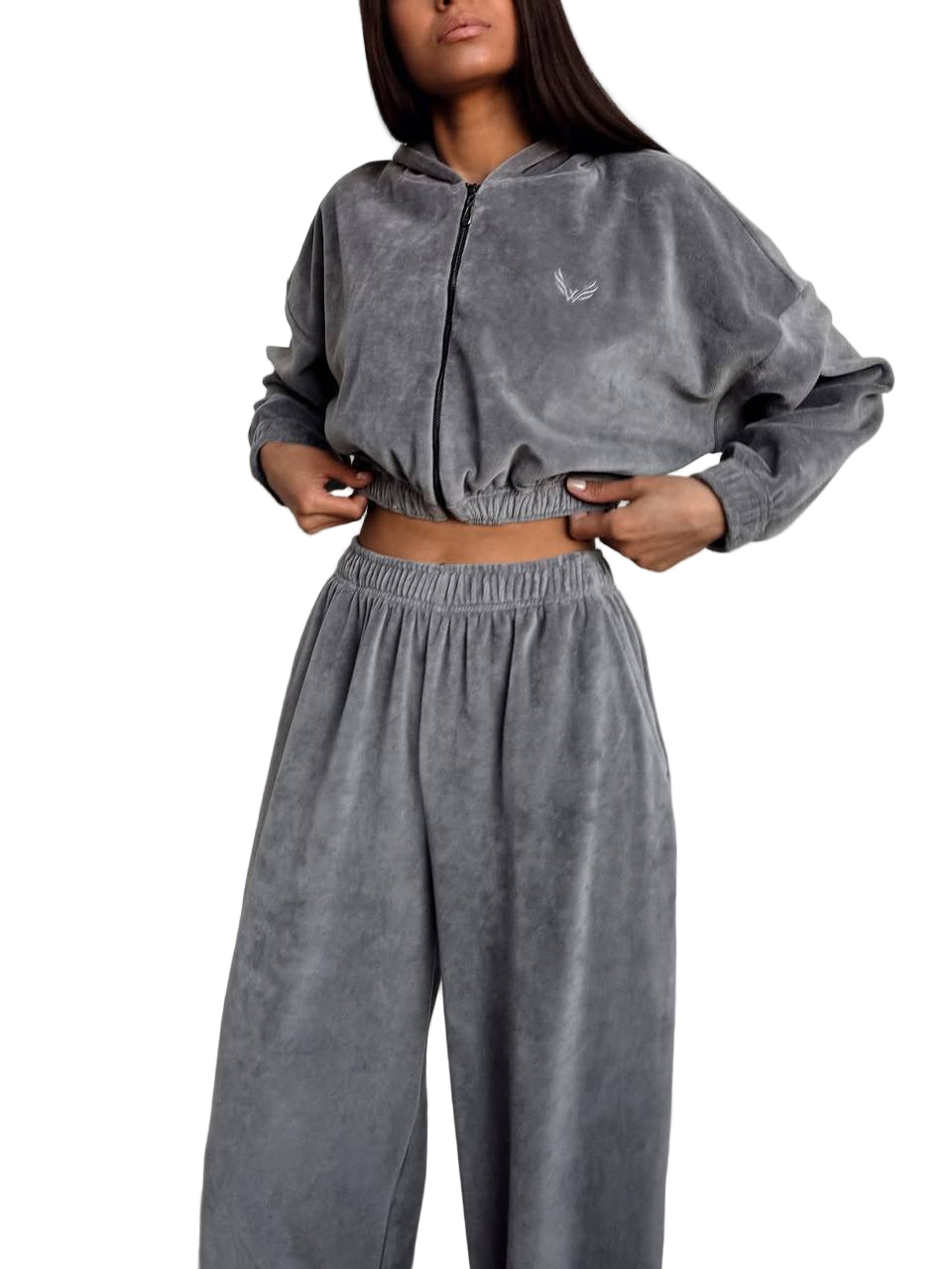 Person wearing a gray tracksuit with a brand logo on a white background
