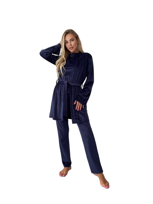 Woman wearing a navy blue outfit with a belt on a white background