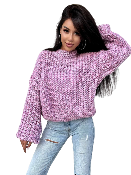 Woman wearing a pink knitted sweater and light blue jeans on a white background