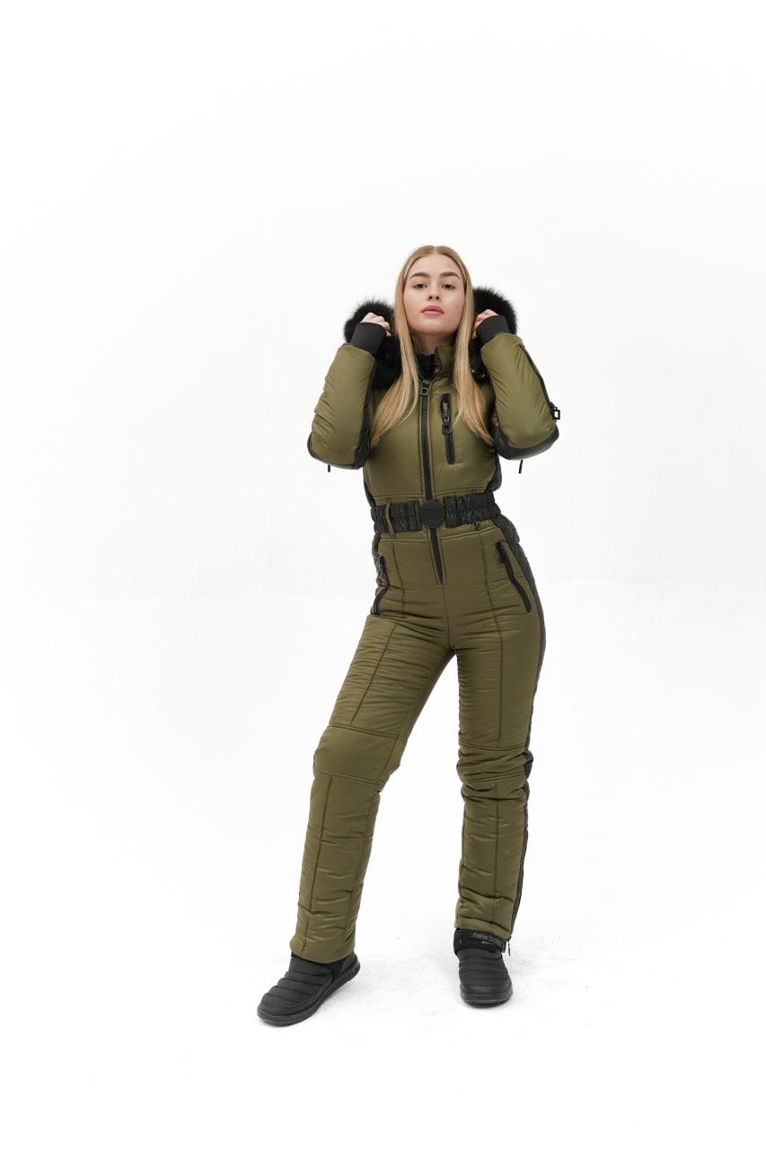 Person wearing a green snowsuit on a white background