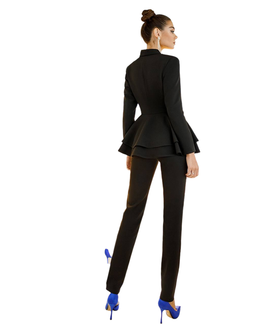 Woman wearing a black suit with blue high heels on a white background