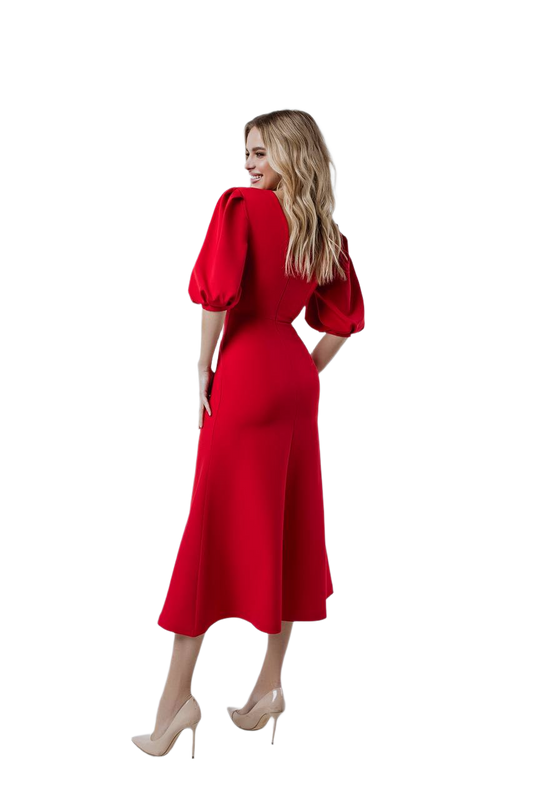Woman wearing a red dress with puff sleeves on a white background