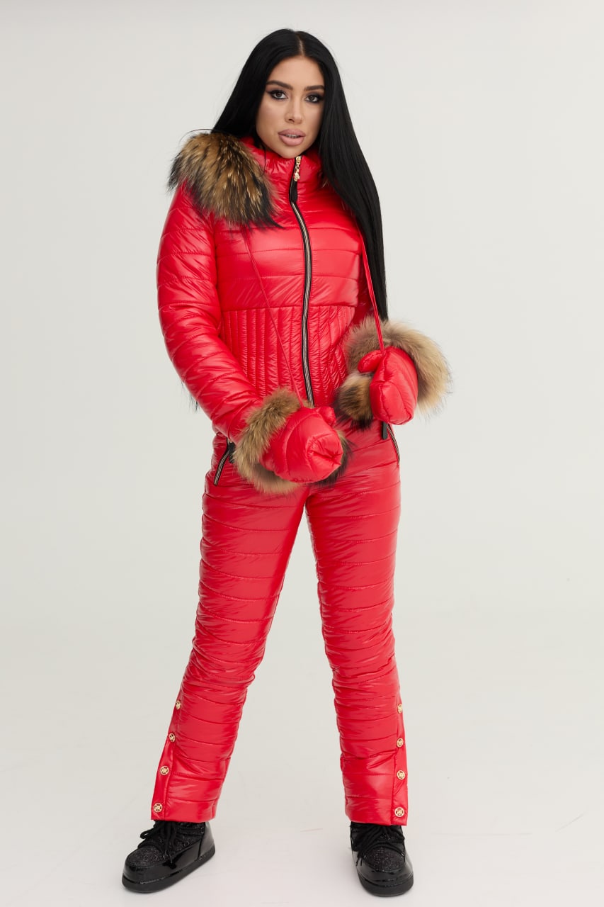 Person wearing a red puffer suit with fur trim on a white background