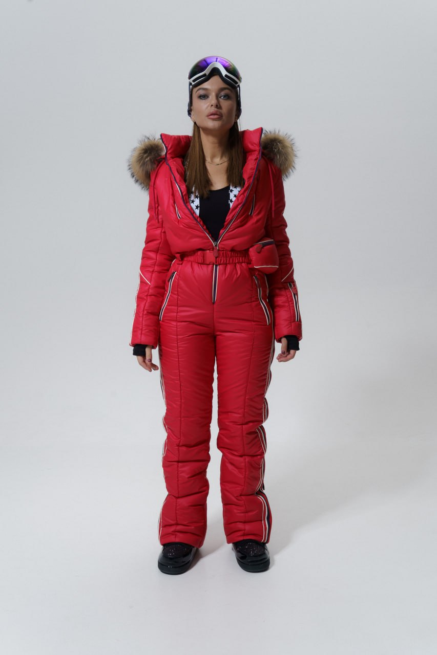 Person wearing a red puffer suit with fur hood on a white background