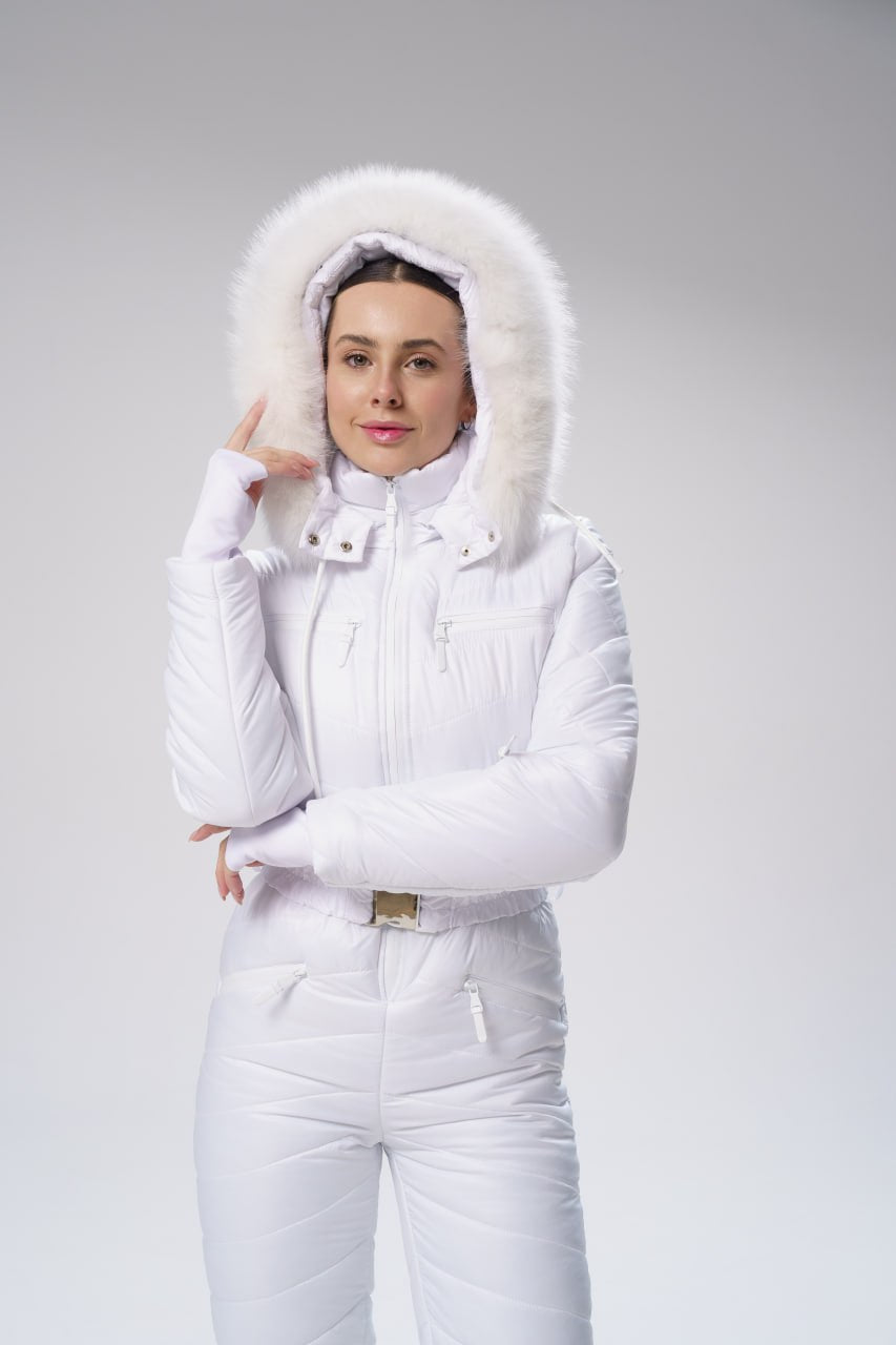 Person wearing a white winter outfit with a fur-lined hood on a gray background