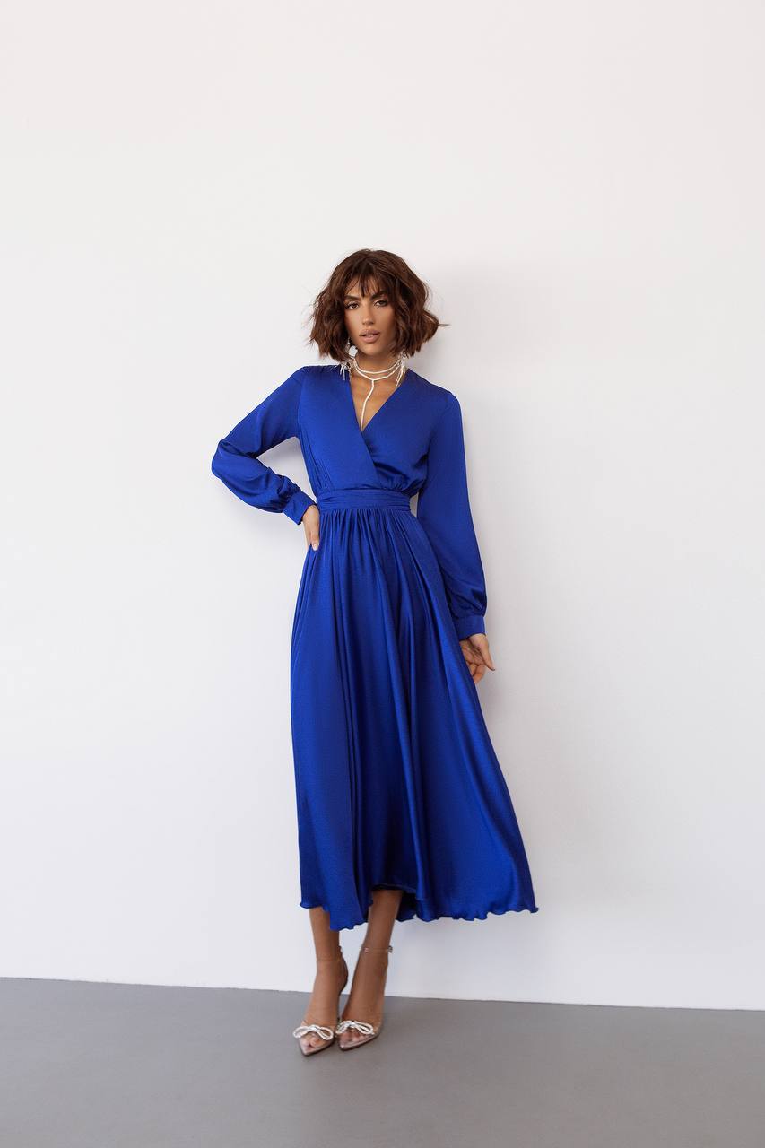 Woman wearing a blue dress against a white background