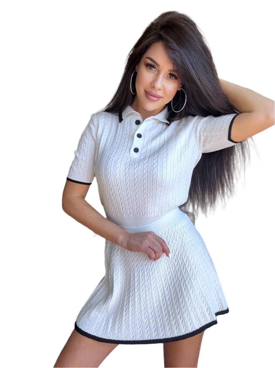 Woman wearing a white dress with black trim on a white background