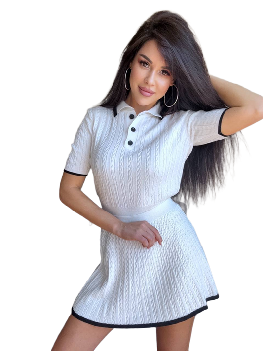 Woman wearing a white dress with black trim on a white background