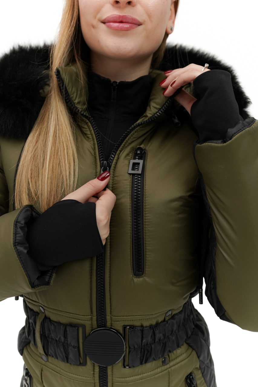 Person wearing a green winter jacket with black fur trim on a white background