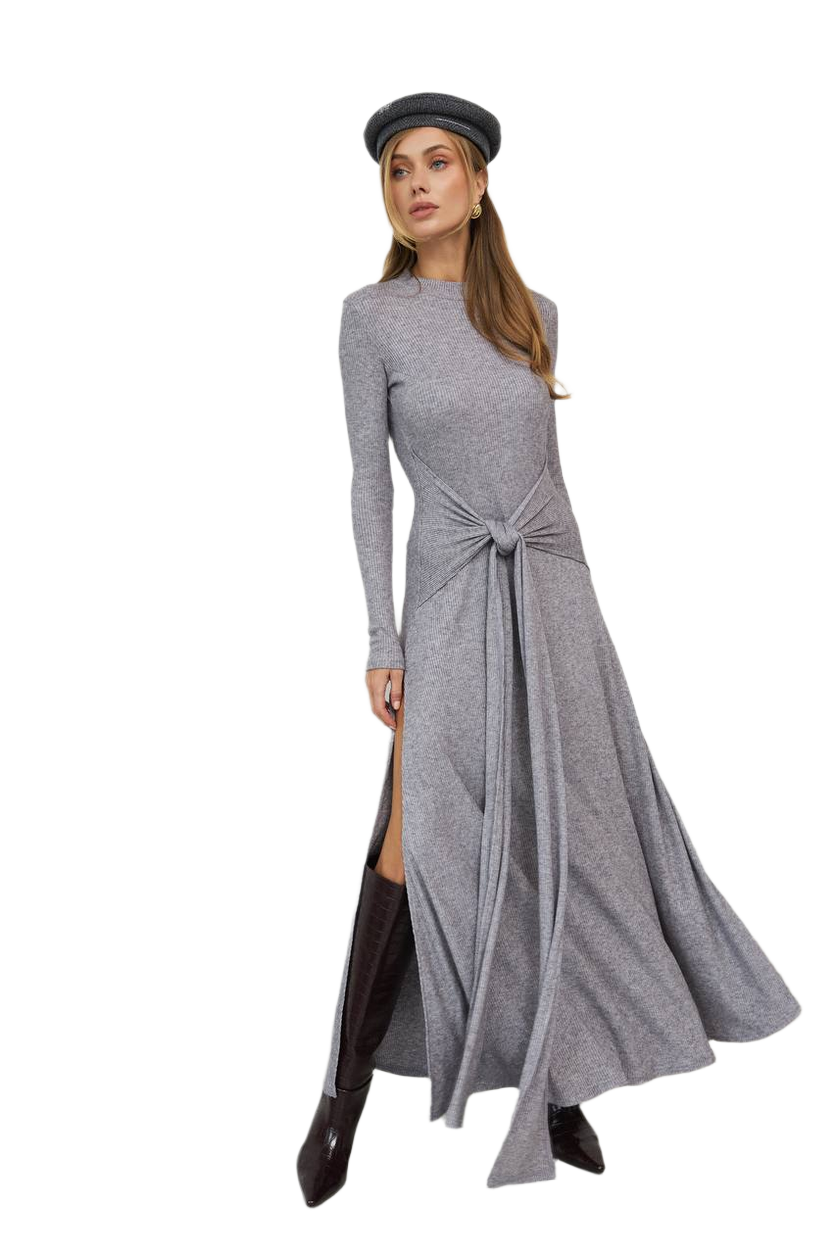 Woman wearing a gray long-sleeve dress with a knot detail on a white background
