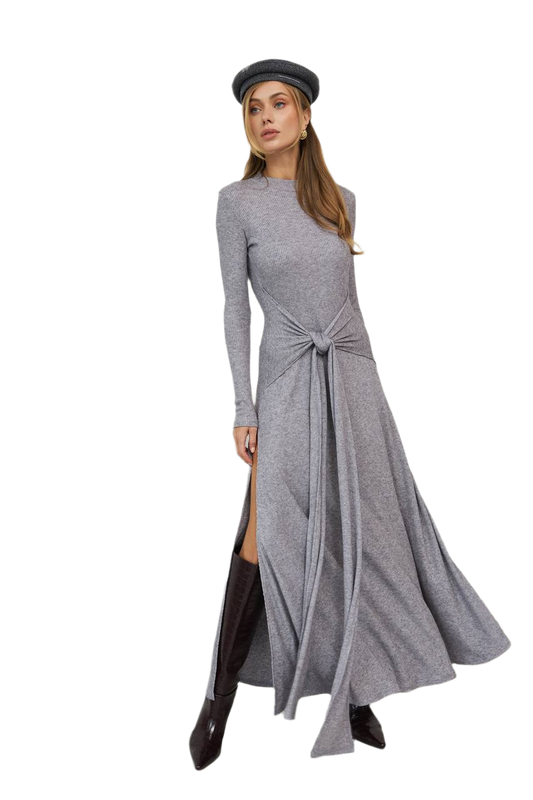 Woman wearing a gray long-sleeve dress with a knot detail on a white background