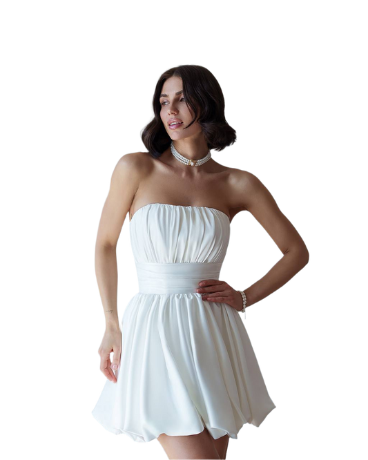 Woman wearing a white strapless dress on a white background