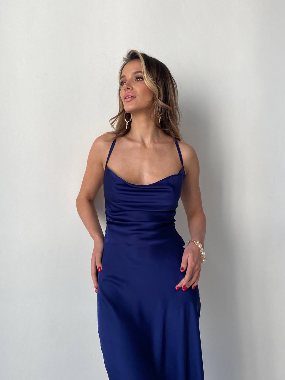 Woman wearing a blue dress against a plain background