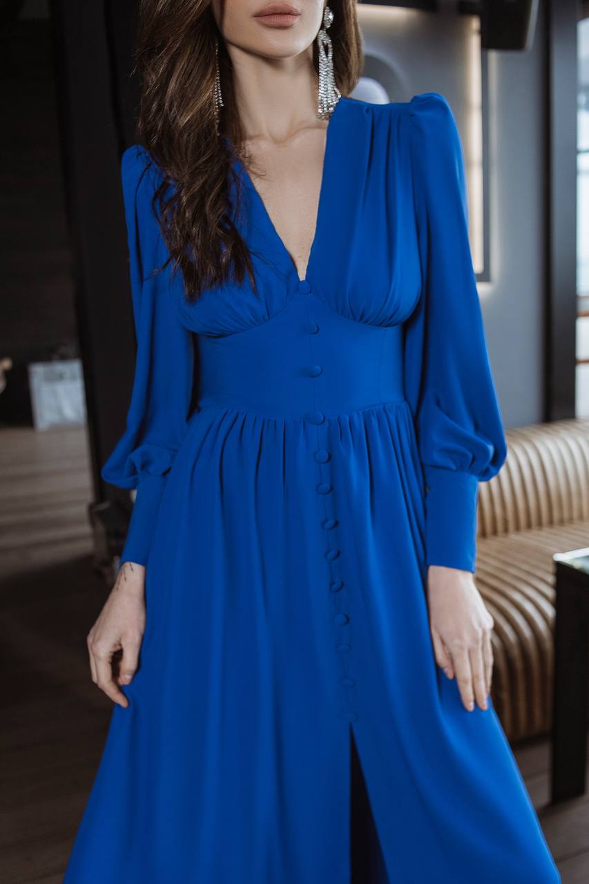 Woman wearing a blue dress with a blurred background