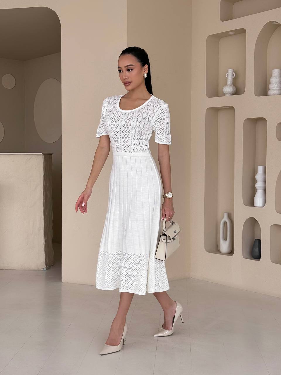 Woman wearing a white lace dress in a modern interior setting