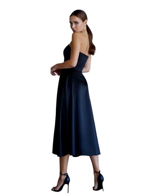 Woman wearing a navy blue strapless dress on a white background