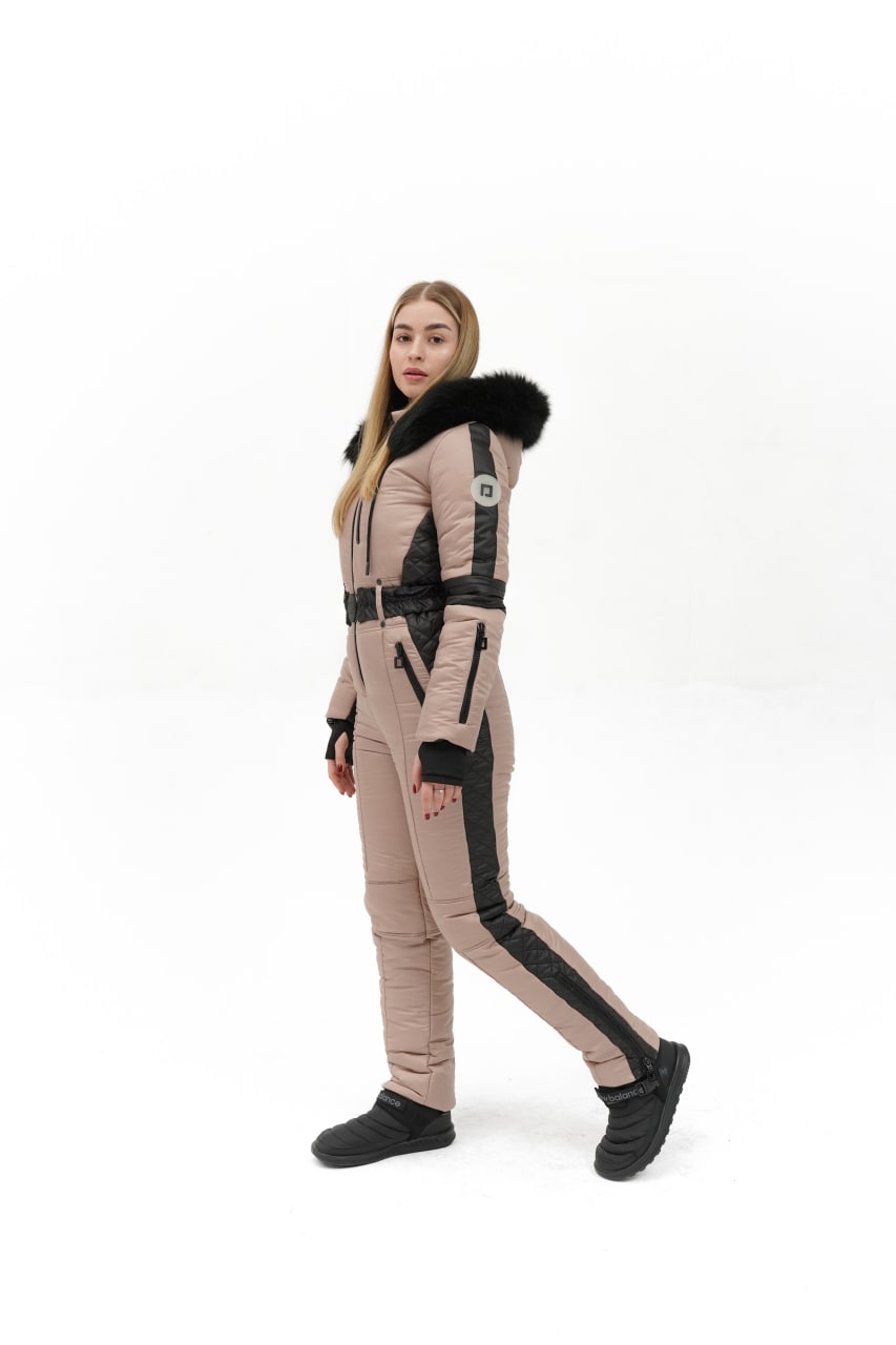 Person wearing a futuristic beige and black outfit on a white background