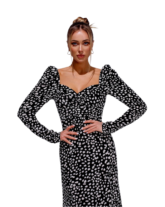 Woman wearing a black and white patterned dress on a white background