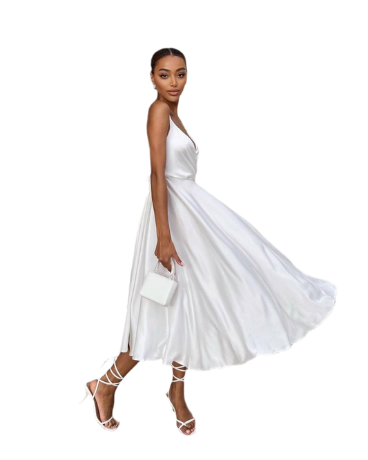 Woman wearing a white dress with a plain background