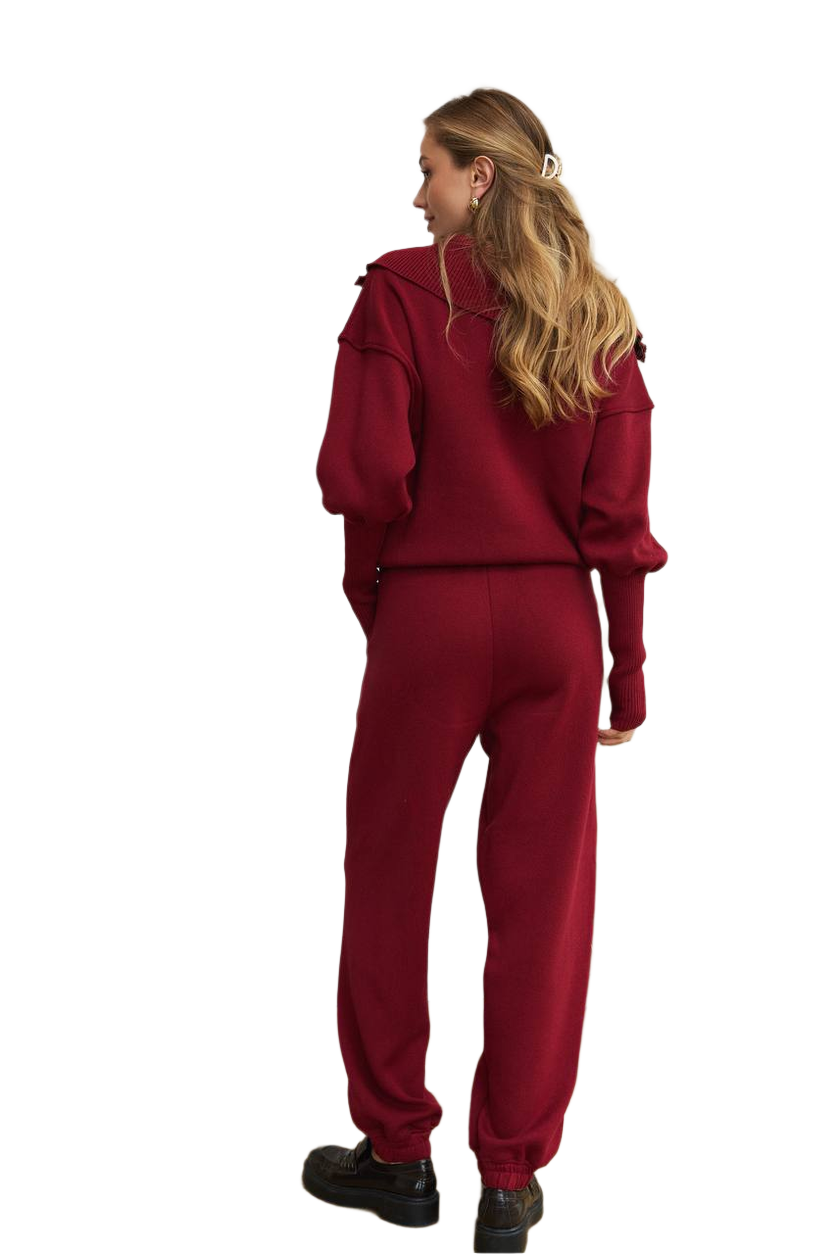 Person wearing a red tracksuit on a white background