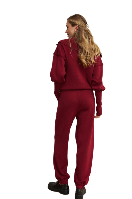 Person wearing a red tracksuit on a white background