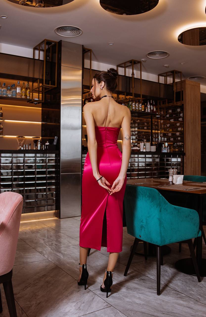 Woman in a red dress standing in a modern restaurant setting