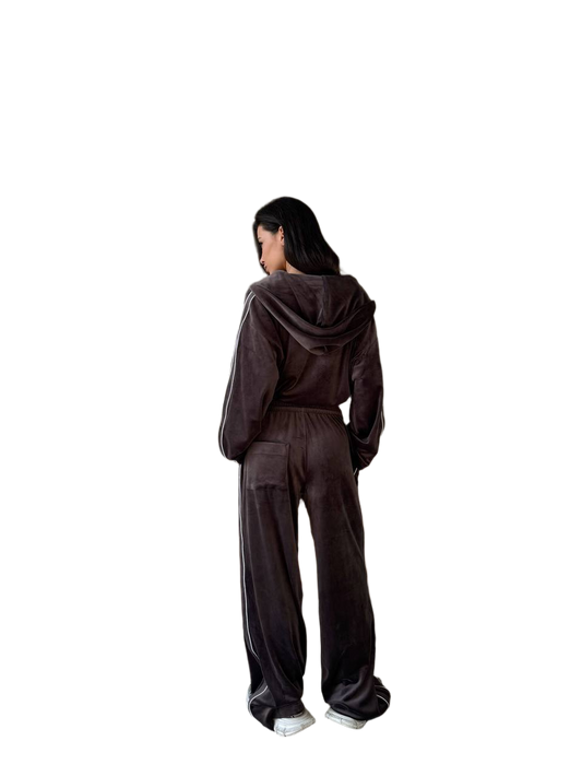 Person wearing a brown tracksuit from behind on a white background