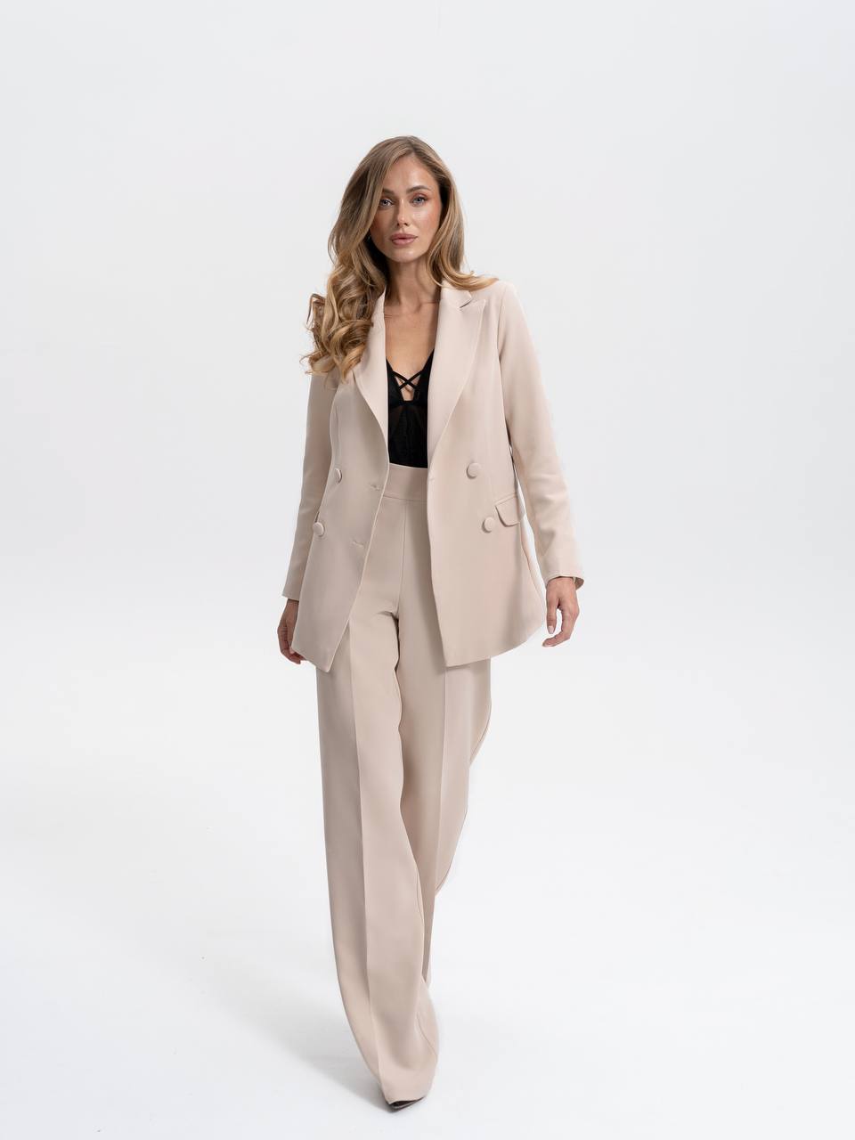 Woman wearing a beige suit on a white background