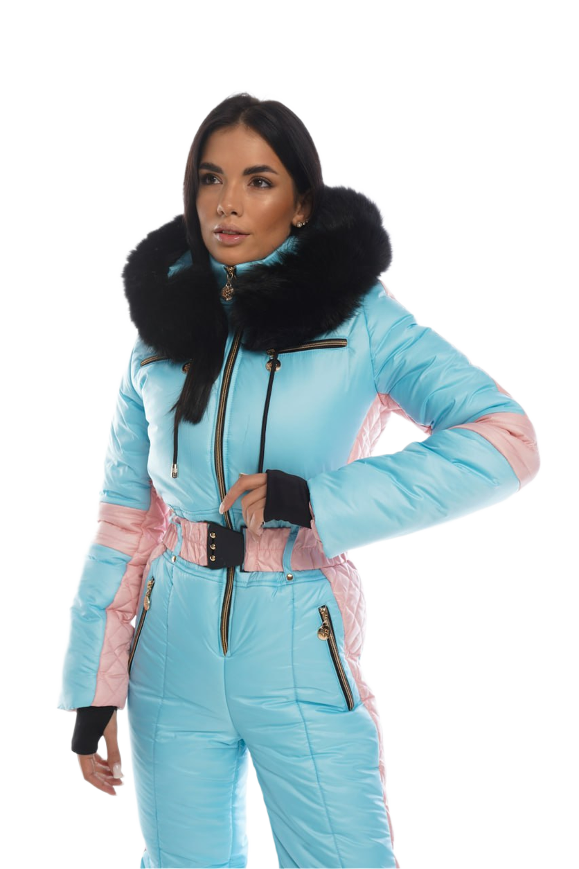 Woman wearing a light blue ski suit with pink accents on a white background