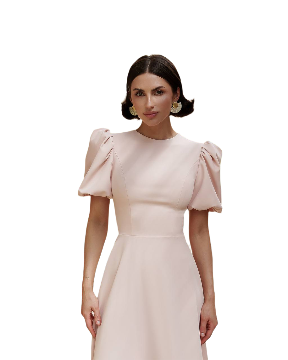 Woman wearing a light pink dress with puffed sleeves on a white background